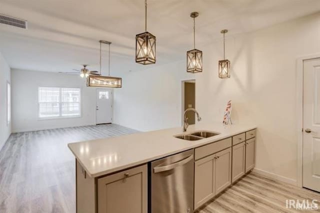 kitchen with stainless steel dishwasher, kitchen peninsula, sink, and hanging light fixtures