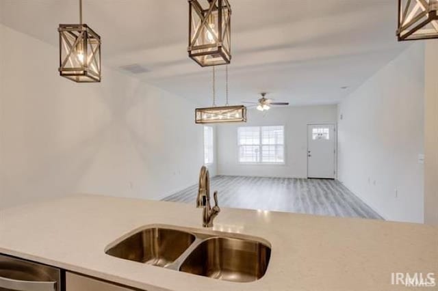 kitchen featuring pendant lighting, ceiling fan, dishwasher, and sink