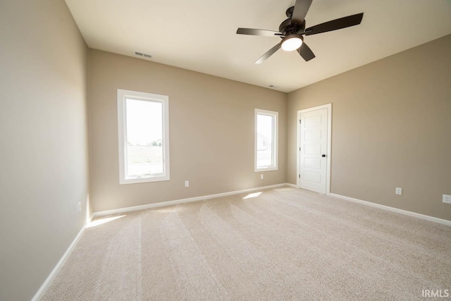 empty room featuring ceiling fan and carpet flooring