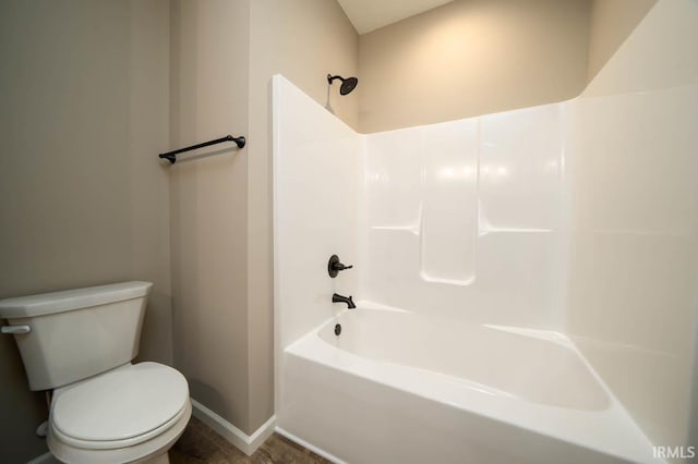 bathroom featuring shower / bathtub combination, toilet, and tile floors