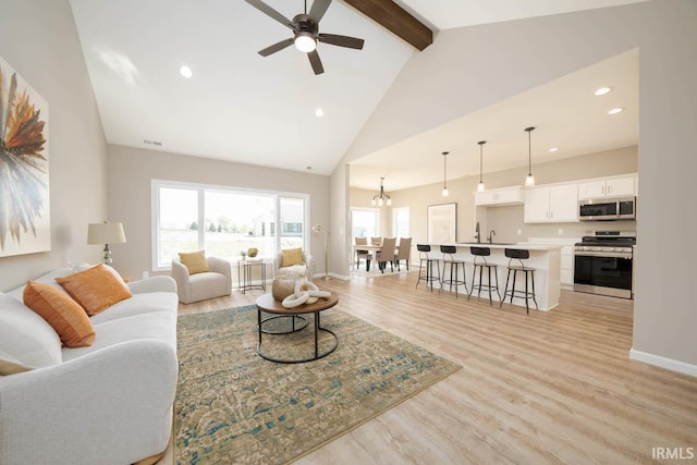 living room featuring high vaulted ceiling, beam ceiling, ceiling fan, and light wood-type flooring