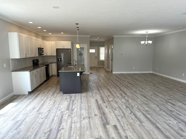 kitchen featuring black appliances, an island with sink, white cabinets, and pendant lighting