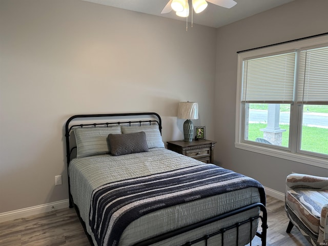 bedroom with wood-type flooring and ceiling fan