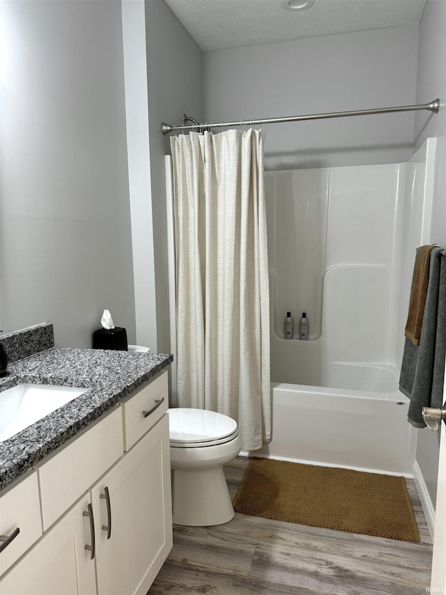 full bathroom with vanity, hardwood / wood-style flooring, toilet, and shower / bath combination with curtain