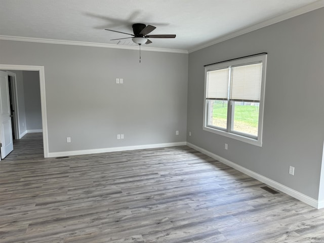 spare room with ornamental molding, wood-type flooring, and ceiling fan