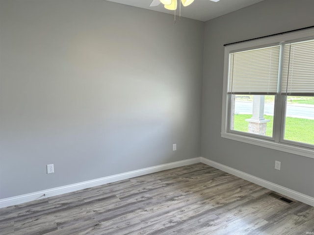 spare room featuring hardwood / wood-style floors and ceiling fan