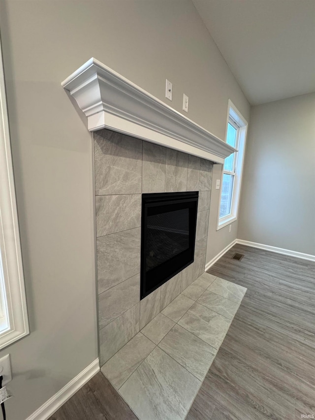 details featuring hardwood / wood-style floors and a fireplace