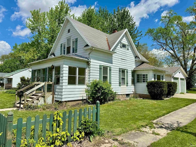 exterior space with a garage and a front lawn