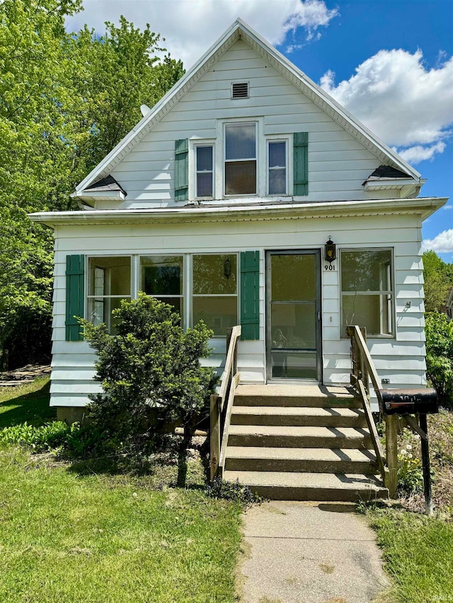 bungalow-style home featuring a front yard