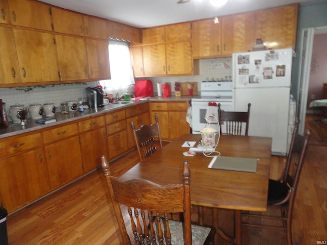 dining room with sink and light wood-type flooring