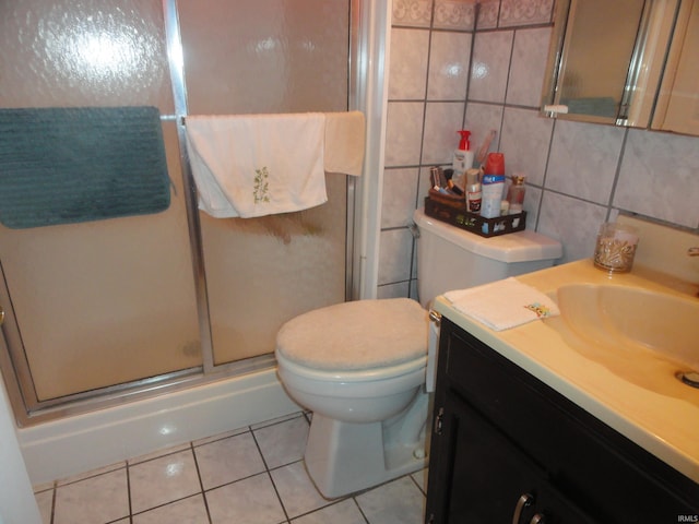 bathroom with tile walls, oversized vanity, backsplash, toilet, and tile flooring