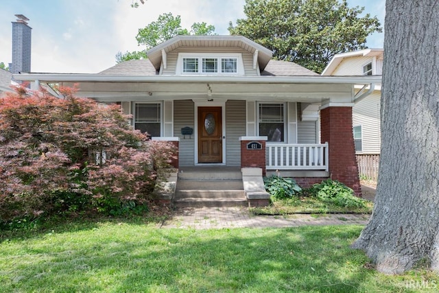 bungalow-style home with a front yard and a porch