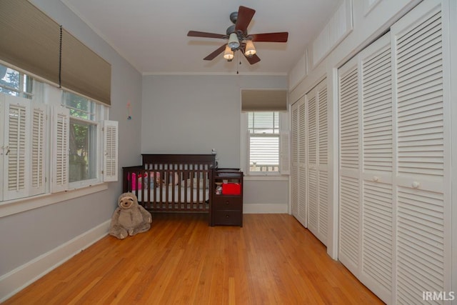 bedroom with light hardwood / wood-style flooring and ceiling fan