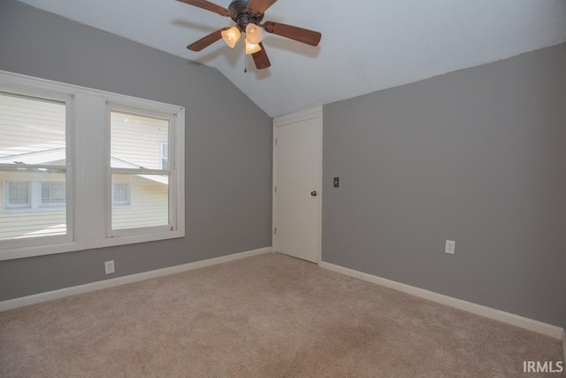 empty room with carpet floors, ceiling fan, and vaulted ceiling