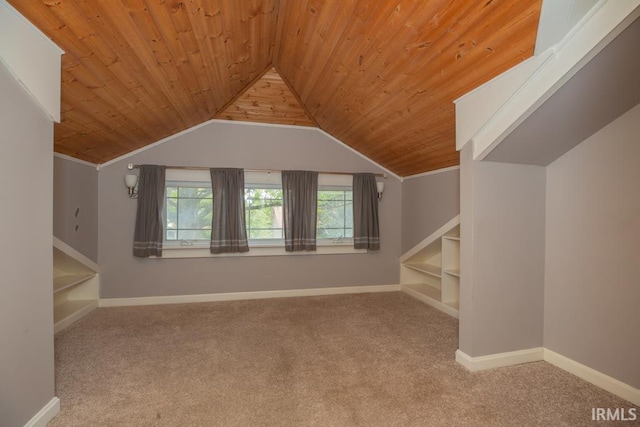 bonus room featuring wood ceiling, carpet flooring, built in shelves, and lofted ceiling