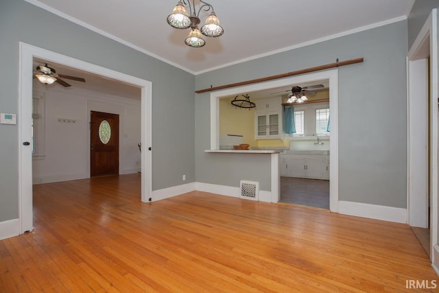 interior space with ornamental molding, light hardwood / wood-style flooring, and ceiling fan with notable chandelier