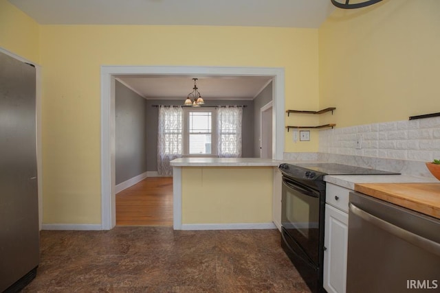 kitchen featuring black electric range oven, hanging light fixtures, white cabinets, backsplash, and stainless steel dishwasher