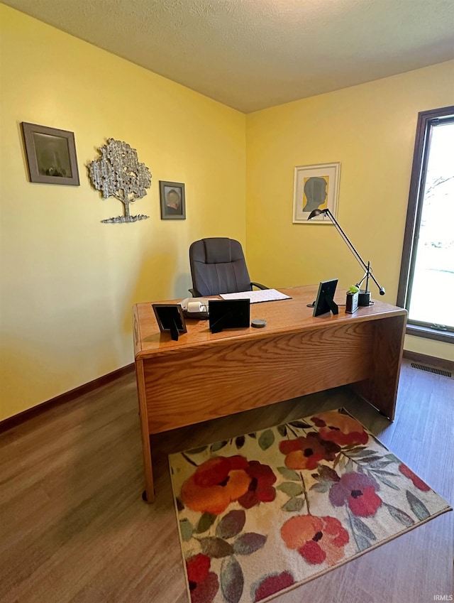 office area featuring wood-type flooring and a textured ceiling