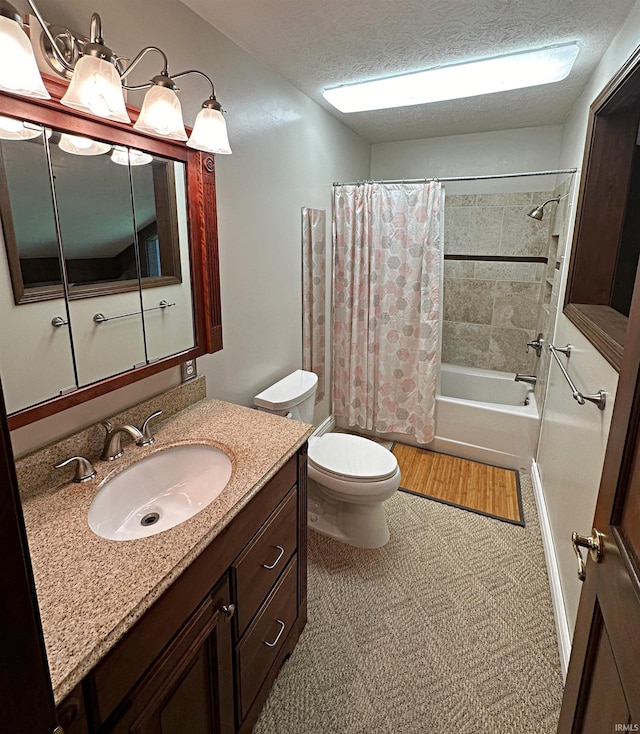 full bathroom with shower / tub combo with curtain, large vanity, toilet, and a textured ceiling