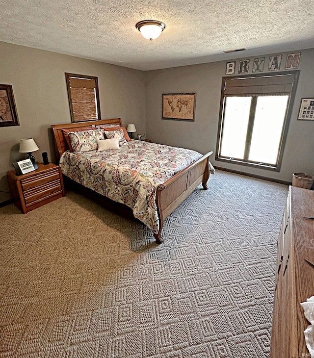 carpeted bedroom with a textured ceiling