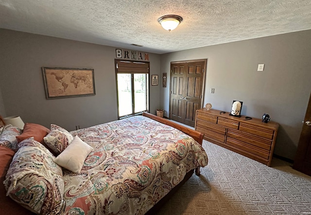 bedroom featuring a closet, carpet, and a textured ceiling