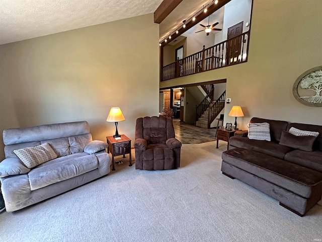 living room featuring high vaulted ceiling, carpet, ceiling fan, and a textured ceiling