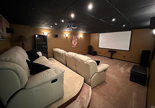 carpeted cinema with a drop ceiling