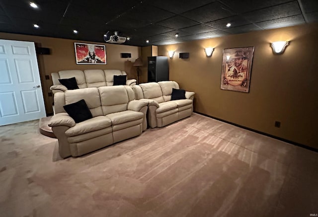 cinema room with carpet and a paneled ceiling