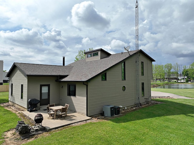 back of property with central AC, a yard, and a patio