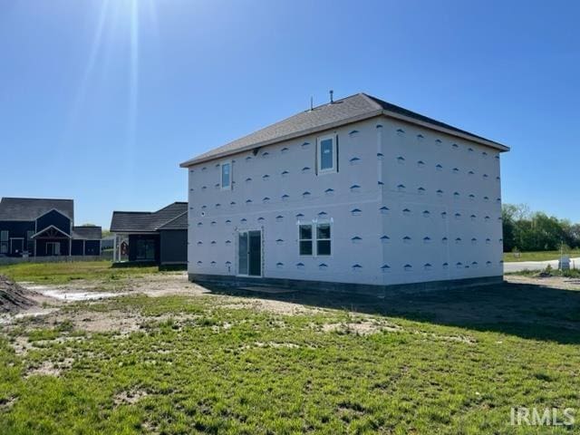 rear view of property with a lawn