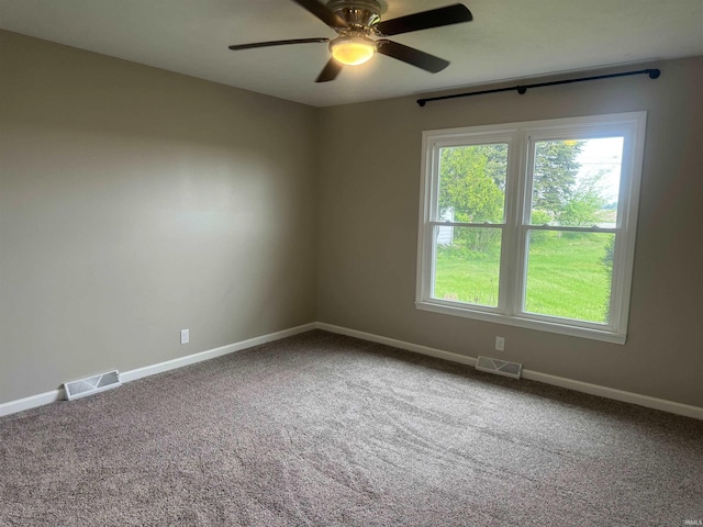 empty room with ceiling fan and carpet flooring