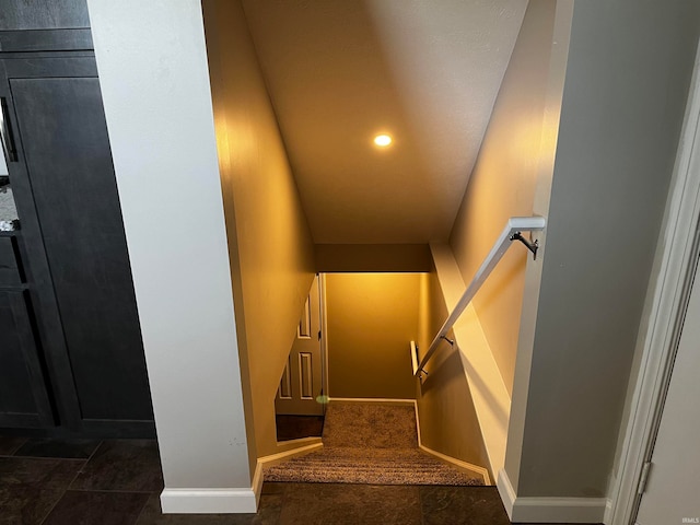 stairs with dark tile flooring