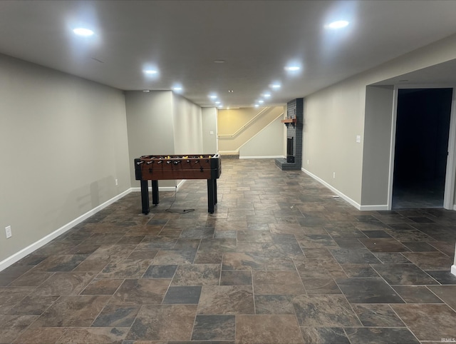 recreation room featuring dark tile flooring