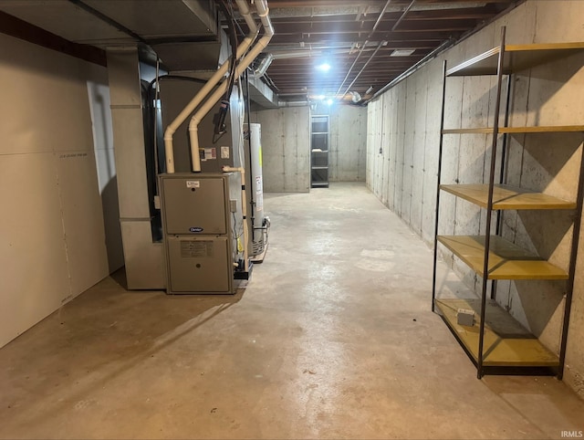 basement featuring water heater and heating utilities