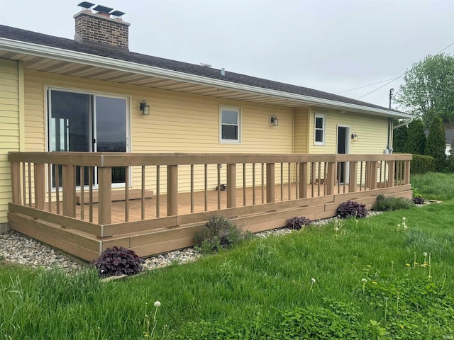 rear view of house featuring a yard and a wooden deck