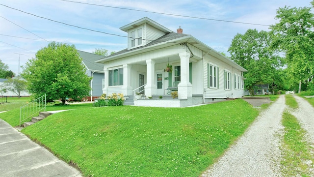 view of front of house featuring a front lawn and covered porch