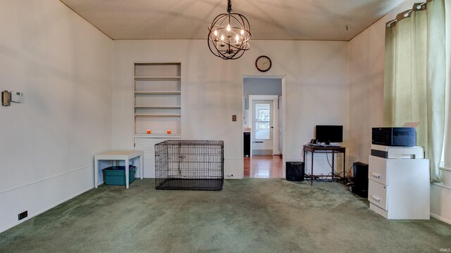 interior space with built in features, a chandelier, and carpet flooring