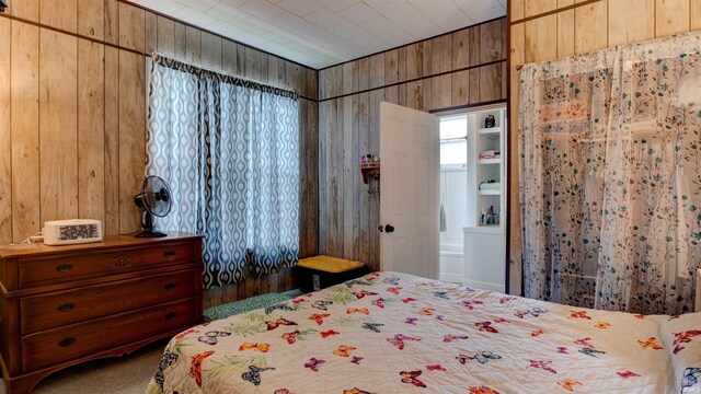 bedroom featuring wooden walls