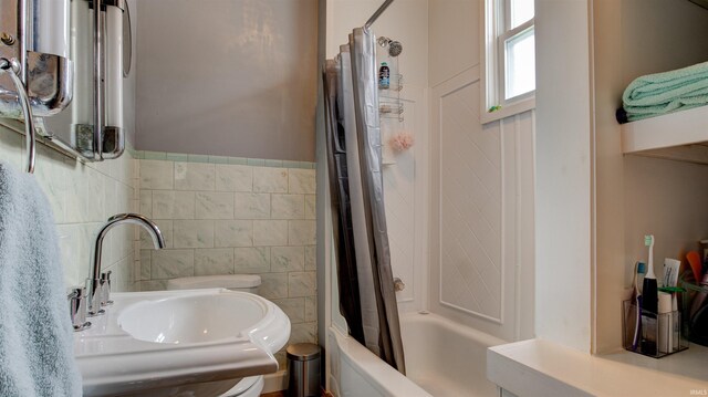 bathroom featuring sink and shower / bath combination with curtain