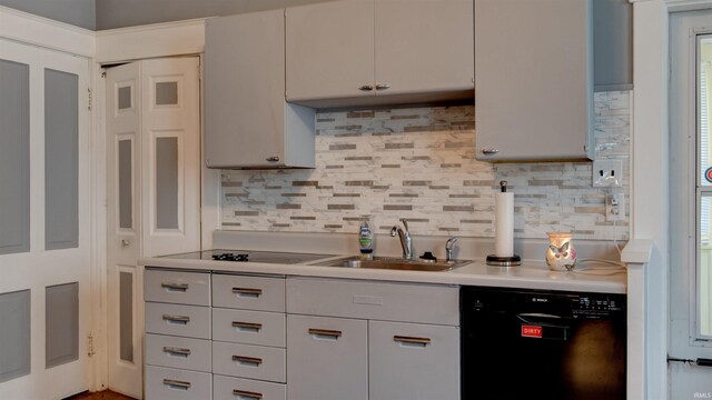 kitchen with backsplash, a wealth of natural light, black appliances, and sink