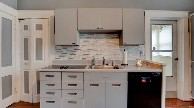 kitchen with dark hardwood / wood-style flooring, backsplash, sink, and black appliances