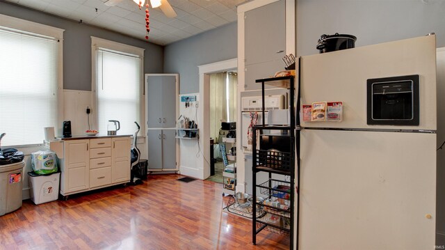 kitchen with wood-type flooring, ceiling fan, and white refrigerator