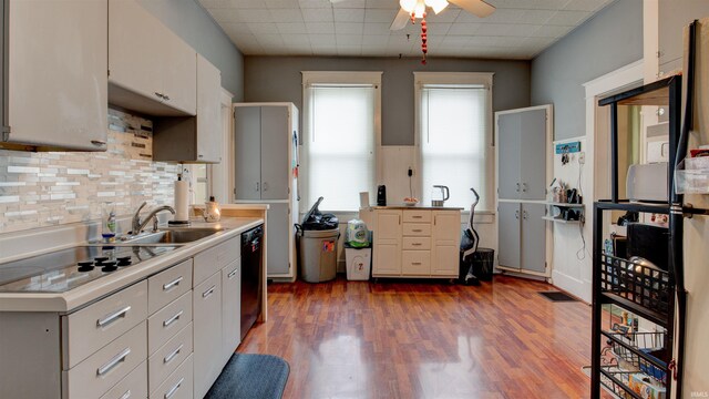 kitchen featuring ceiling fan, black appliances, hardwood / wood-style flooring, white cabinets, and sink