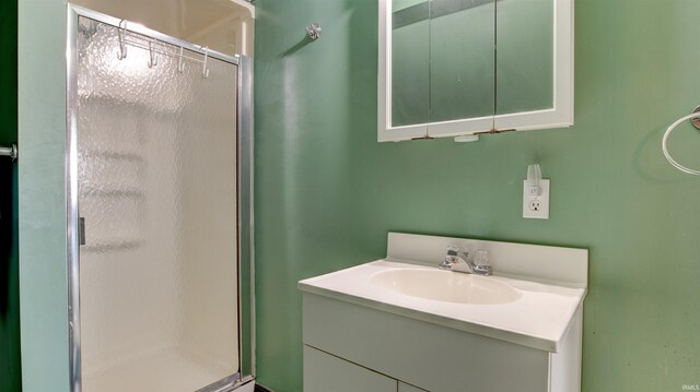 bathroom featuring large vanity and an enclosed shower