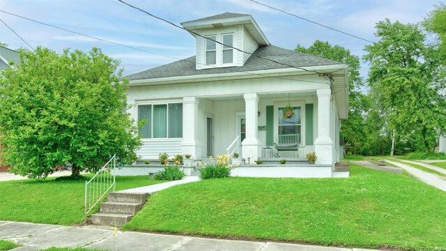 view of front of home with a front lawn and covered porch