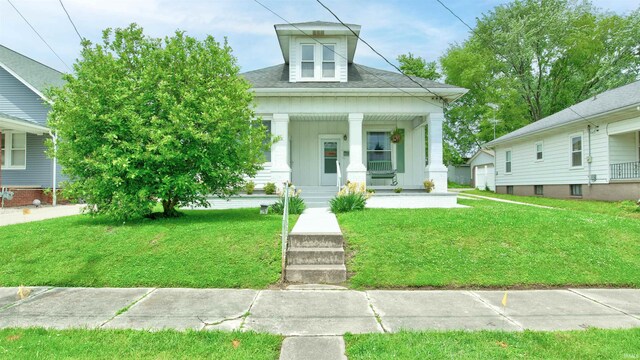 view of front of property with a porch and a front yard