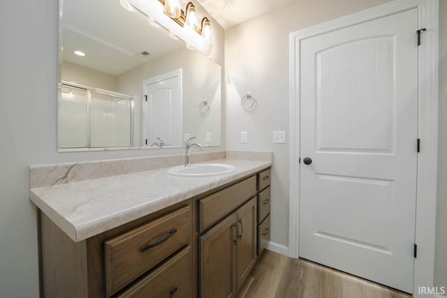 bathroom with hardwood / wood-style flooring and vanity