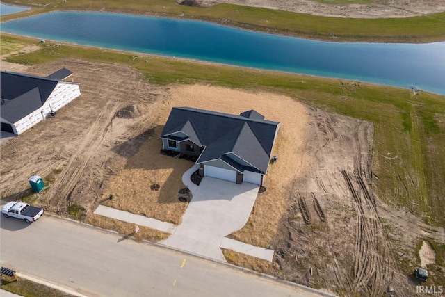 birds eye view of property with a water view