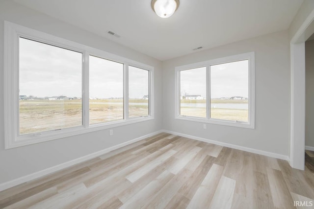 spare room featuring light hardwood / wood-style flooring