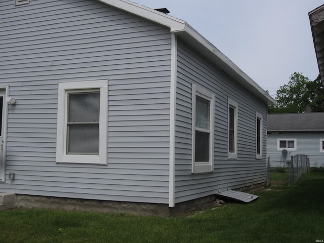 view of property exterior with a lawn